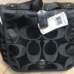 NWT Coach make-up travel bag, black. Zip closure.